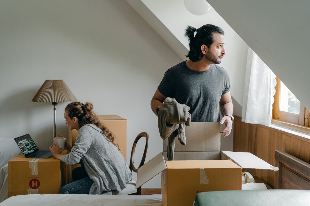 Couple unpacking boxes after moving abroad